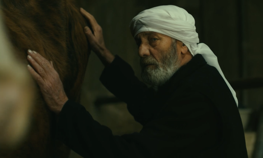 Still from The Stranger/Al Garib of man with horse