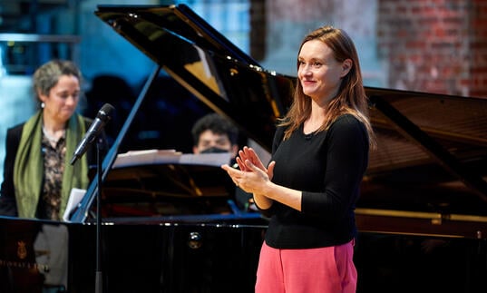 Presenter Rachel Leach clapping.