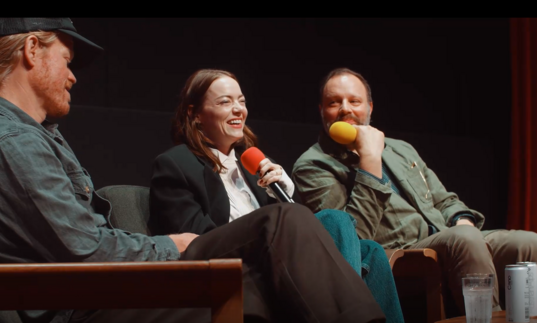 Jesse Plemmons, Emily Stone and Yorgos Lanthimos laugh on stage during a screentalk. 