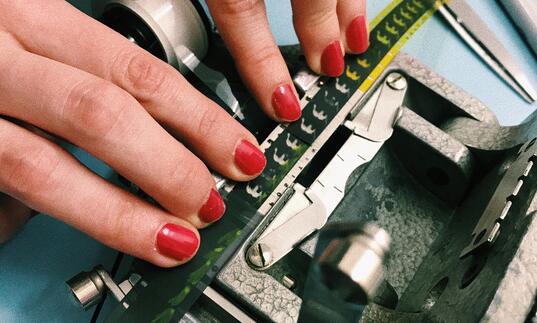 Image of a person's hand fixing a n old camera